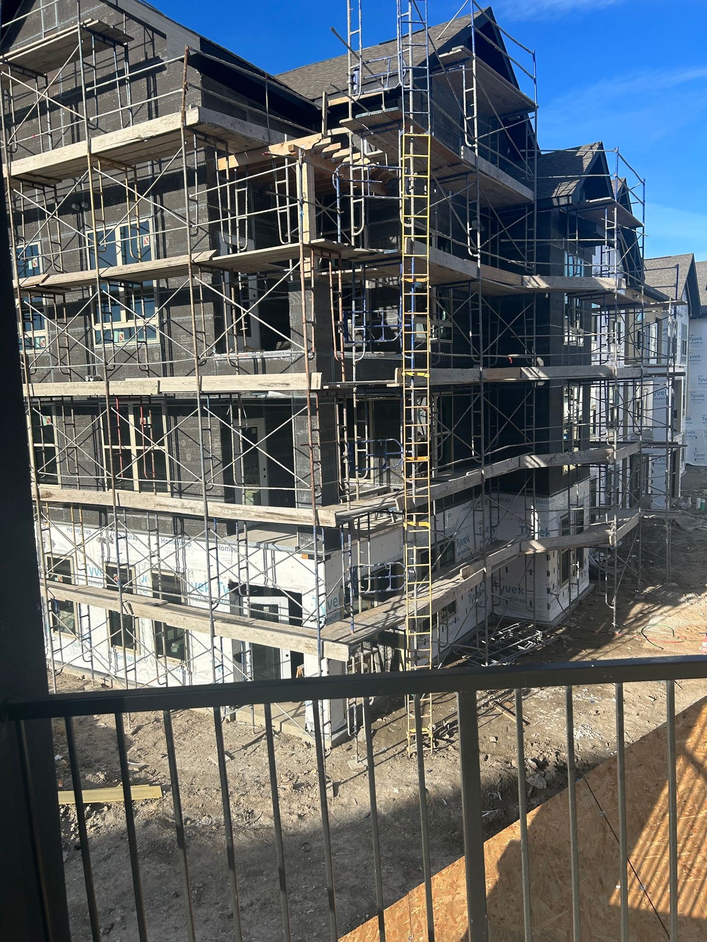 Siding installation with scaffolding on a mid rise apartment complex 